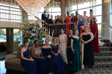 Maryland Teacher of the Year finalists wearing formal wear gather under a chandelier