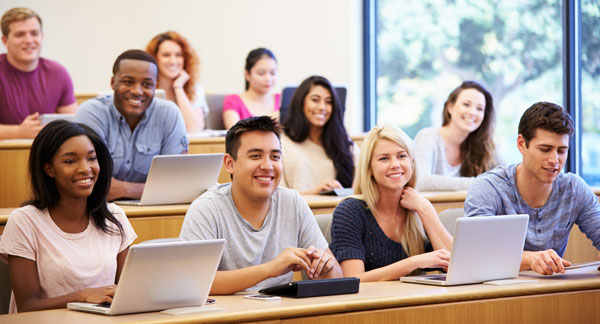 Students using laptops and digital tablets in class