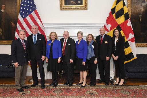 6 people holding certificates stand with Maryland Governor Larry Hogan and Maryland State Superintendent of Schools Dr. Karen B. Salmon